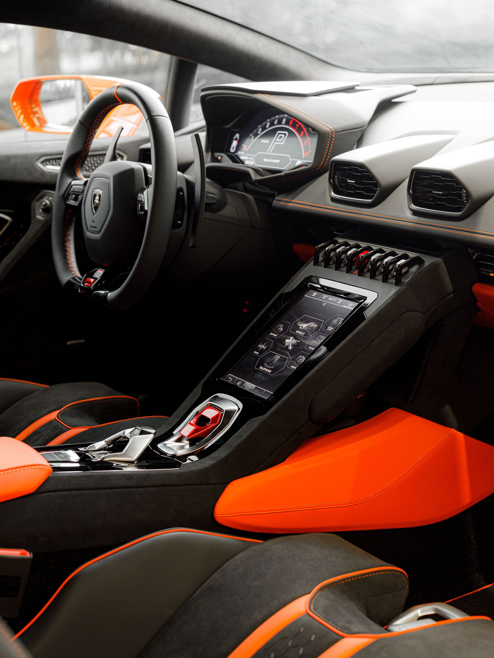 High-end sports car dashboard with advanced digital controls in a sleek, modern design.